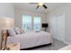 Cozy bedroom with a comfortable bed, neutral tones, and a ceiling fan for a relaxing atmosphere at 6827 Citrus Creek Ln, Tampa, FL 33625