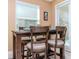 Cozy dining nook with a rustic table, barstool seating, and natural light from the window at 6827 Citrus Creek Ln, Tampa, FL 33625