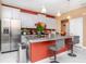 Modern kitchen featuring an island with seating, gray cabinets, granite counters, and stainless appliances at 6827 Citrus Creek Ln, Tampa, FL 33625
