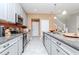 Galley kitchen boasting gray cabinets, granite countertops, stainless steel appliances, and recessed lighting at 6827 Citrus Creek Ln, Tampa, FL 33625