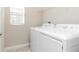 Laundry room with modern white washer and dryer at 6827 Citrus Creek Ln, Tampa, FL 33625