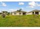Large backyard with green grass and mature trees is ideal for outdoor living at 6882 Silverado Ranch Blvd, Zephyrhills, FL 33541