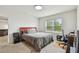 Cozy bedroom featuring a large window for natural light, neutral carpet and a work desk at 6882 Silverado Ranch Blvd, Zephyrhills, FL 33541