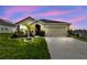 Charming single-story home with well-manicured lawn, desert landscaping, and a two-car garage at 6882 Silverado Ranch Blvd, Zephyrhills, FL 33541