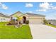 Charming one-story home featuring a manicured lawn and a two car garage at 6882 Silverado Ranch Blvd, Zephyrhills, FL 33541