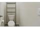Powder room featuring a toilet, shelving unit for storage and neutral decor at 6882 Silverado Ranch Blvd, Zephyrhills, FL 33541