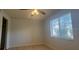 Cozy bedroom with laminate flooring, a ceiling fan, and a window for natural light at 7506 Presley Pl # 108, Tampa, FL 33617