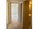 Hallway with tile flooring leading to a bedroom and bathroom at 7506 Presley Pl # 108, Tampa, FL 33617