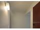 Bright hallway with neutral walls and a modern light fixture, leading to other areas at 7506 Presley Pl # 108, Tampa, FL 33617