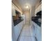 Efficient kitchen featuring white cabinets, tile backsplash, and essential appliances at 7506 Presley Pl # 108, Tampa, FL 33617