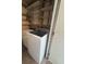 Convenient laundry room with washer, dryer, and built-in shelving at 7506 Presley Pl # 108, Tampa, FL 33617
