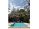 Community pool surrounded by mature trees at 7506 Presley Pl # 108, Tampa, FL 33617