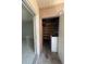 View of the storage area with a washer and plenty of shelving space for organization at 7506 Presley Pl # 108, Tampa, FL 33617