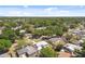 Scenic aerial view of a neighborhood with mature trees, showcasing the home's location and surrounding community at 7520 Orpine N Dr, St Petersburg, FL 33702