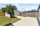 Backyard featuring large storage shed with barn doors and full wooden fence at 7520 Orpine N Dr, St Petersburg, FL 33702