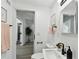 Bright bathroom with modern fixtures, stylish sink, and view to the hall with hardwood floors at 7520 Orpine N Dr, St Petersburg, FL 33702