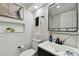 Modern bathroom featuring a sleek vanity, black fixtures, and marble-look shower at 7520 Orpine N Dr, St Petersburg, FL 33702