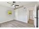 Bright bedroom featuring ceiling fan, window with natural light, and closet for storage at 7520 Orpine N Dr, St Petersburg, FL 33702