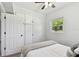 Cozy bedroom featuring a ceiling fan, window with natural light, and closet for storage at 7520 Orpine N Dr, St Petersburg, FL 33702
