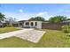 Charming home with a well-maintained lawn, walkway, and inviting curb appeal at 7520 Orpine N Dr, St Petersburg, FL 33702