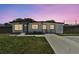 Charming single-story home featuring modern design, a well-manicured lawn, and a private driveway at 7520 Orpine N Dr, St Petersburg, FL 33702