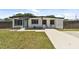 Charming single-story home with a well-manicured lawn and a concrete driveway at 7520 Orpine N Dr, St Petersburg, FL 33702