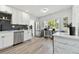 Bright kitchen with new appliances, updated cabinets, and a stylish backsplash at 7520 Orpine N Dr, St Petersburg, FL 33702