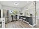 Open kitchen with stainless steel appliances, sleek countertops, bar stool seating, and ample counter space at 7520 Orpine N Dr, St Petersburg, FL 33702