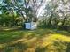 Large backyard featuring mature trees and a storage shed at 851 Easy St, Brooksville, FL 34601