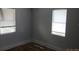 Neutral bedroom with dual windows and gray walls at 851 Easy St, Brooksville, FL 34601