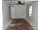 Bedroom featuring a ceiling fan, window, and open door at 851 Easy St, Brooksville, FL 34601