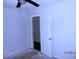 Empty bedroom with white door and ceiling fan at 851 Easy St, Brooksville, FL 34601