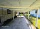 Open carport attached to home, providing covered parking and access at 851 Easy St, Brooksville, FL 34601