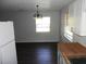 Open-concept dining room with dark wood floors and a view from the kitchen at 851 Easy St, Brooksville, FL 34601