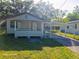 Charming single-story home featuring a cozy front porch and convenient carport at 851 Easy St, Brooksville, FL 34601