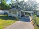 Inviting single-story home with a covered carport and well-maintained landscaping at 851 Easy St, Brooksville, FL 34601