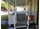Covered front porch with access steps at 851 Easy St, Brooksville, FL 34601
