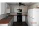 Updated kitchen with white cabinets, butcher block countertops, and appliances at 851 Easy St, Brooksville, FL 34601