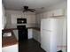 Bright kitchen features black appliances, white cabinetry, and a ceiling fan at 851 Easy St, Brooksville, FL 34601
