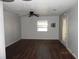 Well-lit living room with laminate flooring, neutral walls, and an exit door at 851 Easy St, Brooksville, FL 34601