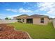 Well-maintained backyard featuring a lush green lawn and a privacy fence for outdoor enjoyment at 8529 Hunters Fork Loop, Ruskin, FL 33573