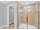 A large, tiled walk-in shower is included in this bathroom with glass doors at 8529 Hunters Fork Loop, Ruskin, FL 33573