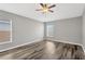 Bedroom with wood flooring, ceiling fan, and natural light from the windows at 8529 Hunters Fork Loop, Ruskin, FL 33573