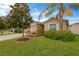 Charming single story home boasts beautiful landscaping, lawn, and palm tree at 8529 Hunters Fork Loop, Ruskin, FL 33573