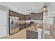 Kitchen features granite countertops, stainless steel appliances, and tile flooring at 8529 Hunters Fork Loop, Ruskin, FL 33573
