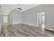 Spacious living room with wood flooring, ceiling fan, and neutral paint at 8529 Hunters Fork Loop, Ruskin, FL 33573