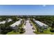 Aerial view of neighborhood street with mature trees and manicured landscaping on a sunny day at 8555 112Th St # 209, Seminole, FL 33772