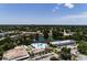 Aerial community view featuring a pond, pool, and shuffleboard courts, surrounded by lush greenery at 8555 112Th St # 209, Seminole, FL 33772