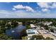 Community aerial view showcasing the pool, pond with fountain, and surrounding trees at 8555 112Th St # 209, Seminole, FL 33772