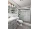 This bathroom features tile flooring, a gray vanity and a glass enclosed shower at 8555 112Th St # 209, Seminole, FL 33772